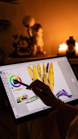 High-resolution digital illustration of a person using a graphics tablet to create digital art at a desk.