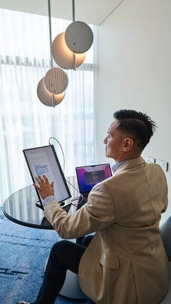 Webcam and video conferencing equipment in a modern meeting room.