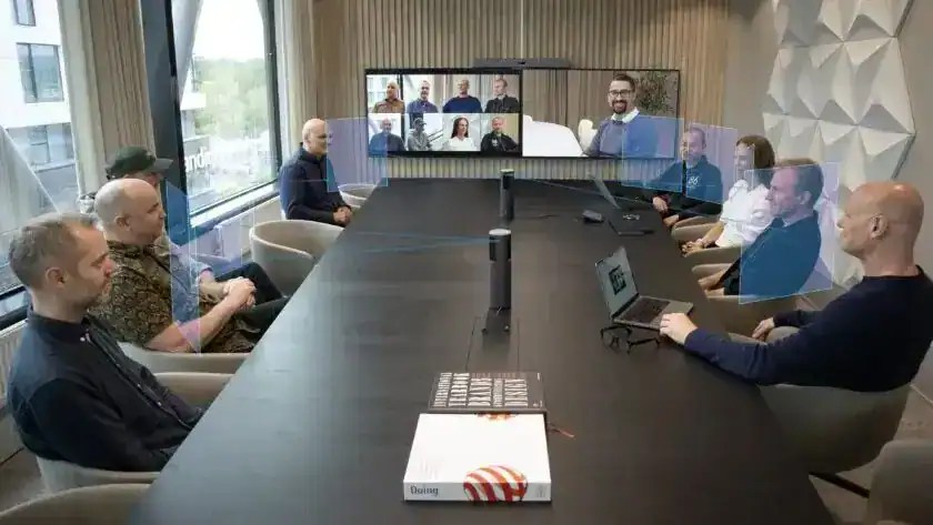 Webcam with facial recognition participating in a video conference meeting.