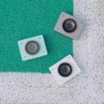 4K webcams and PTZ cameras arranged on colourful textured carpets, showcasing professional audiovisual equipment.