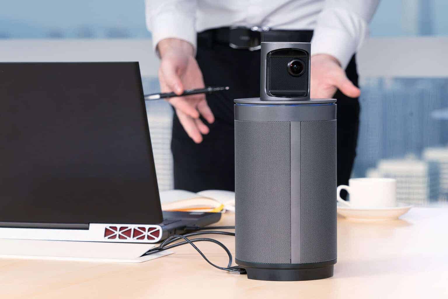 Webcam and videoconferencing equipment on a meeting table.