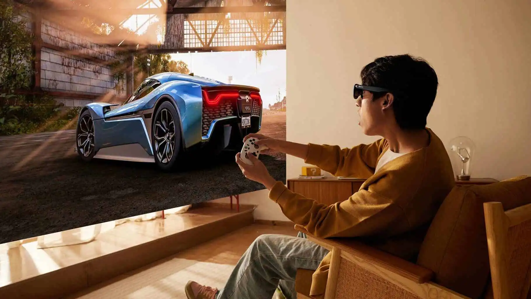 High-tech man with AR glasses controls a sleek blue racing car simulation on a large screen.